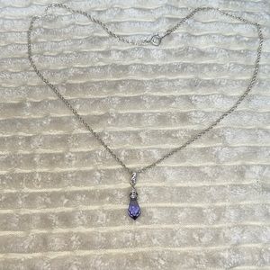 Silver fashion necklace with purple stone pendant.